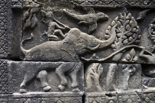 Angkor Wat sculptural relief in stone of ancient stylized elephant with warrior riding his back