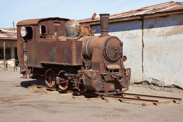 Fototapeta na wymiar Derelict and rusting steam train at the historic Humberstone Saltpeter Works in the Atacama Desert near Iquique in Chile. The site is now an open air museum and a Unesco World Heritage SIte.