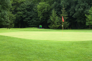 Red flag on a golf course, focus on the flag