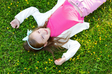 Cute little girl laying in the grass