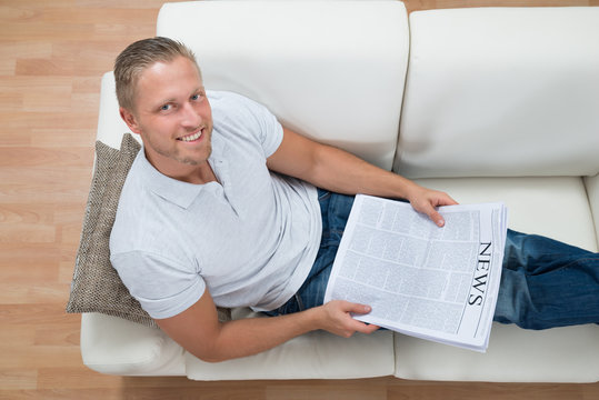 Man On Sofa With Newspaper