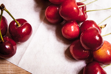 Healthy organic vegetarian super food cherries in clay dish on rustic kitchen table background. Dark photo, rustic style, natural light