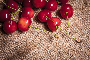 Healthy organic vegetarian super food cherries in clay dish on rustic kitchen table background. Dark photo, rustic style, natural light