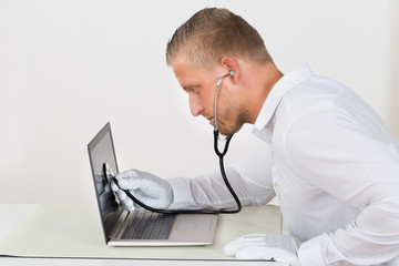 Technician With Stethoscope And Laptop