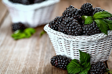 Pile of ripe blackberry with green leaves © circleps