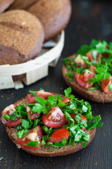 Italian tomato bruschetta with chopped vegetables, herbs and oil