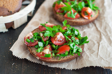 Italian tomato bruschetta with chopped vegetables, herbs and oil