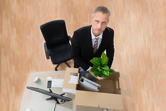 Businessman Packing Personal Things In Box