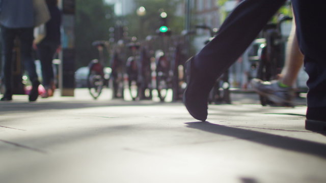 Blurred pedestrians walk past camera 