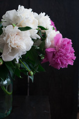 white and pink peonies on rustic wooden background
