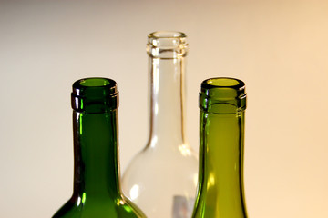 The necks of the white and green wine bottles