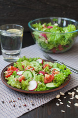 Tomato and cucumber salad with lettuce leafes