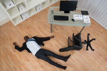 Unconscious Businessman Lying On Floor