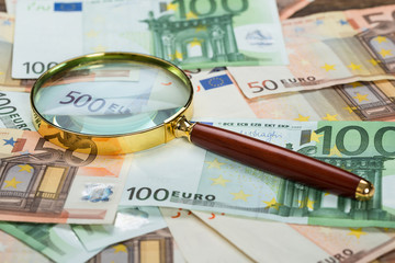Magnifying Glass Over Banknote