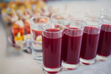 Beautifully decorated catering banquet table with different food snacks and appetizers with sandwich, caviar, fresh fruits on corporate party event or wedding celebration