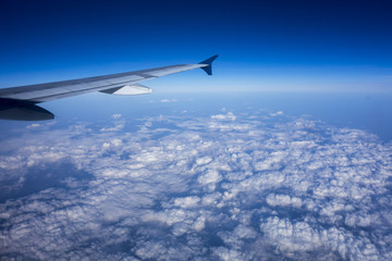 Fototapeta na wymiar Aircraft Wing above Clouds