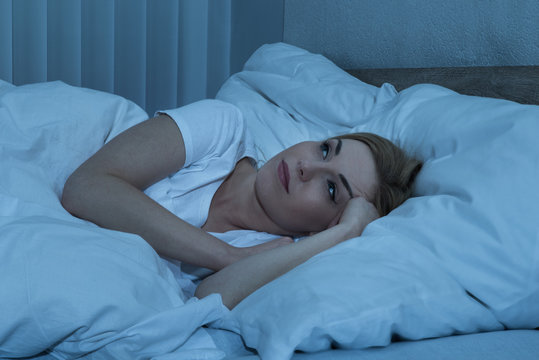 Woman In Bed Suffering From Insomnia