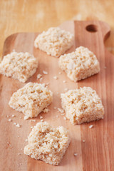 Coconut candy cocada on wooden board