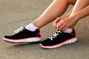 runner woman tying laces closeup