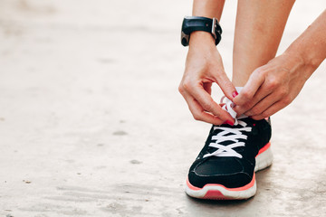 runner woman tying laces closeup