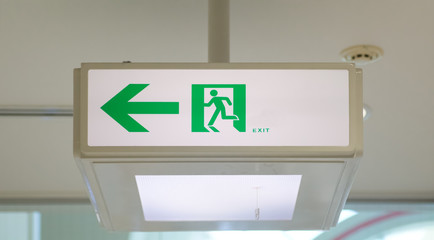 Green emergency exit sign in building
