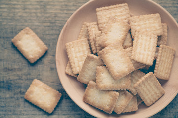 Mini coconut biscuit in wood plate on wood table background