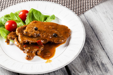 Pork chop with sauce and vegetables