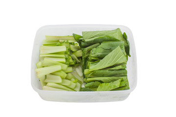Fresh green vegetable in plastic box isolated on white backhround
