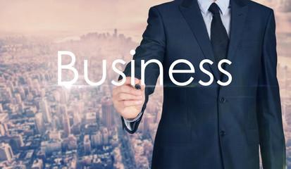 Businessman sketching and writing Business with nice business city background in retro colors.