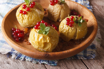 baked apples with honey, mint and red currant close up horizontal
