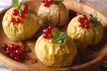 baked apples with honey decorated with fresh red currants close up
