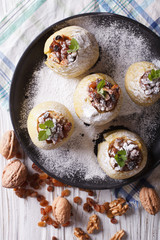 baked apples with raisins close-up vertical view from above

