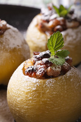 Baked apple stuffed with raisins, nuts and honey macro. vertical
