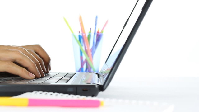 Businessman is typing on laptop and writing notebook. Close-up view and focus at hand of businessman in dolly style. Definition 1280x720 px