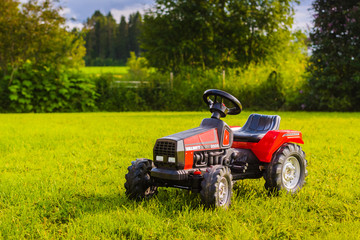 Toy Tractor On The Summer Yard