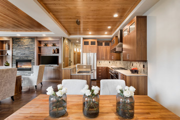 Beautiful interior in new home: dining room, kitchen, and living room with hardwood floors and ceiling