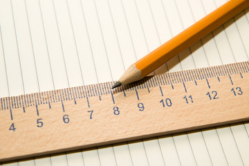 Notepads, pencil and wooden ruler on the old tissue