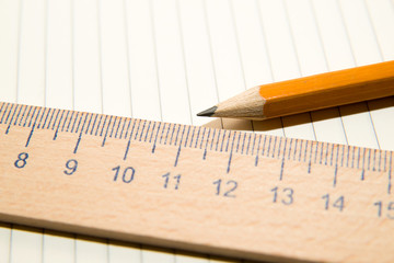 Notepads, pencil and wooden ruler on the old tissue