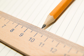 Notepads, pencil and wooden ruler on the old tissue