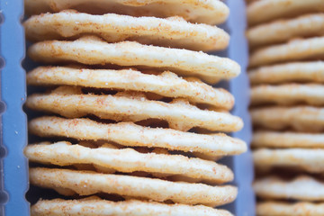 A stack of cheesy rice crackers on a white background.