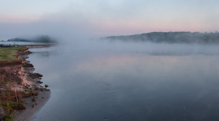 Reflection of the first rays of dawn sunlight in the lake