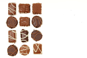 Various chocolates candies on white background, right you can write some text