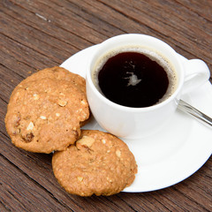 cookies and coffee cup in wood background