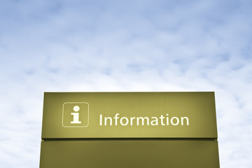 Yellow information sign against a blue sky - concept image