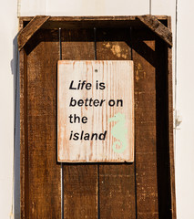 "Life is better on the island" - the inscription on the wall of one of the houses on the island of Paros, Cyclades, Greece.