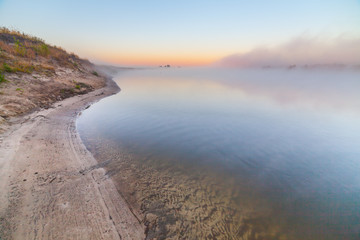 Fototapeta na wymiar summer sunrise over the river with a fog