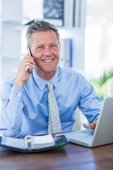 Serious businessman having phone call 