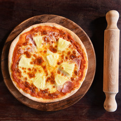 Hawaiian Pizza , pineapple , ham and cheese on the wooden background