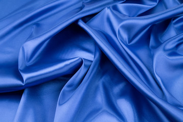 Soft folds of deep blue silk cloth.