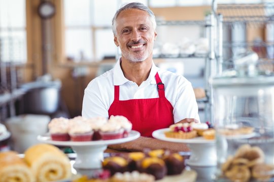 Barista Smiling At Camera Behind Counter